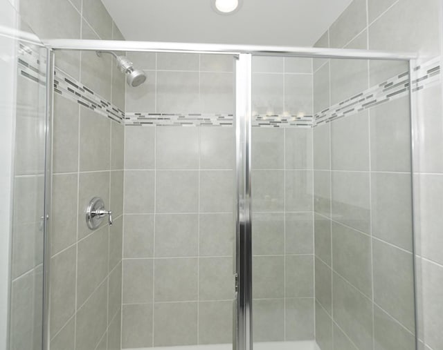 bathroom featuring a shower with door