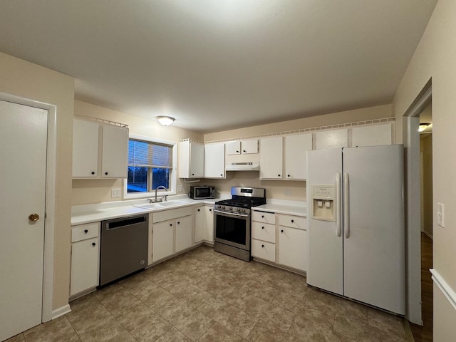 kitchen featuring appliances with stainless steel finishes, sink, and white cabinetry