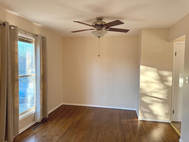 empty room featuring ceiling fan and dark hardwood / wood-style flooring