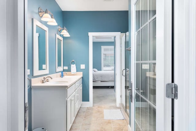 bathroom with a shower with door, tile patterned floors, and vanity