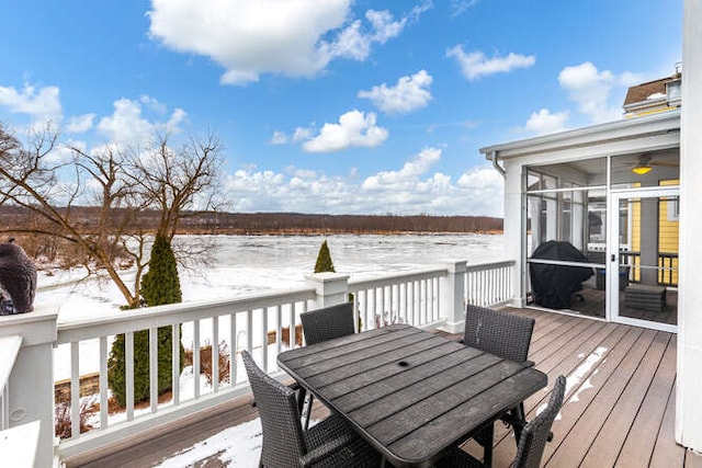 snow covered deck with a sunroom