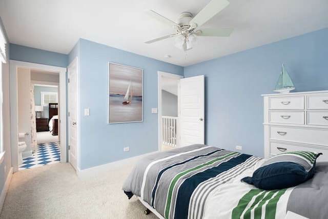 bedroom with ceiling fan, carpet, and ensuite bath