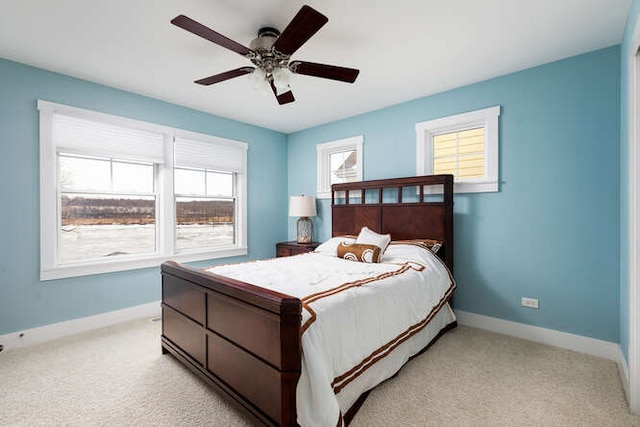 bedroom with ceiling fan and light carpet