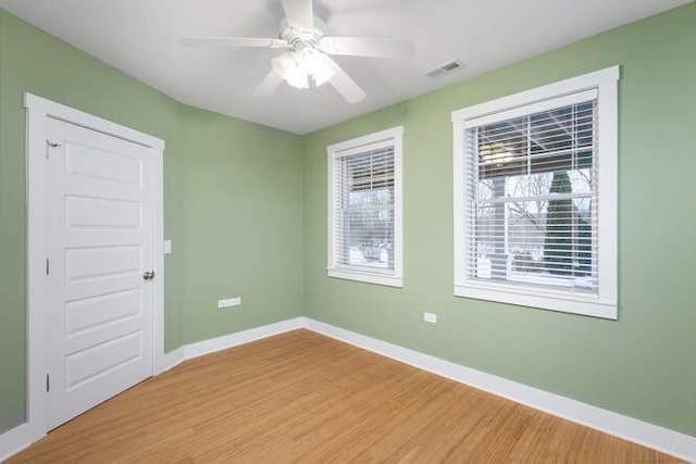 empty room featuring ceiling fan and hardwood / wood-style flooring