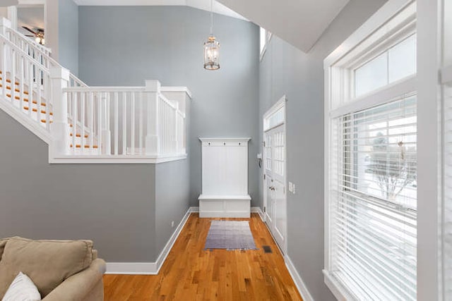 interior space with high vaulted ceiling, hardwood / wood-style floors, and ceiling fan