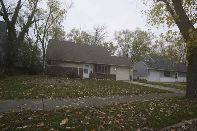 ranch-style home with a garage and a front yard