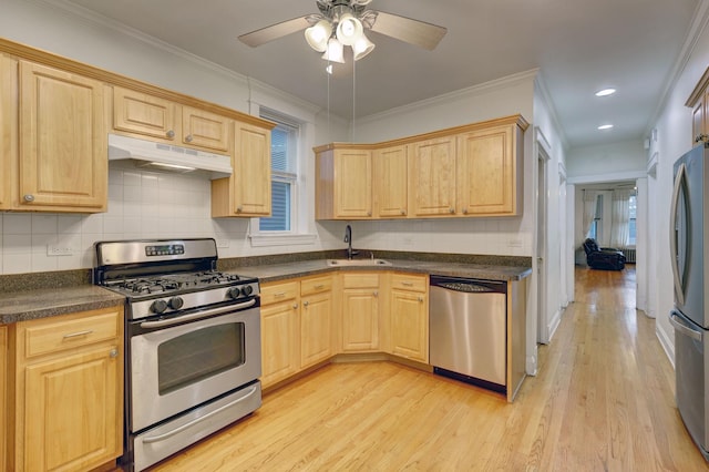 kitchen featuring appliances with stainless steel finishes, light brown cabinets, light hardwood / wood-style floors, sink, and crown molding