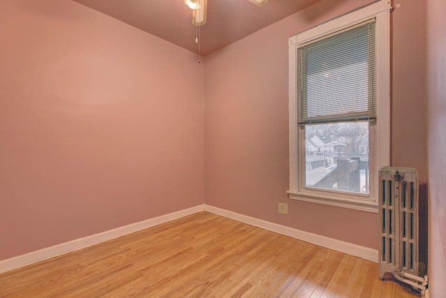 spare room with ceiling fan and light hardwood / wood-style flooring