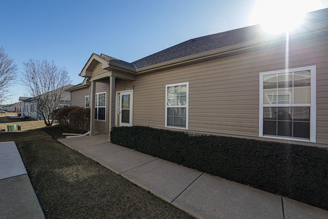 view of side of property with a lawn