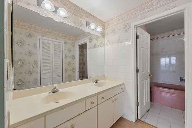 bathroom with vanity, tile patterned floors, and a washtub