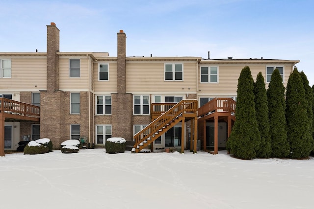 snow covered property featuring a wooden deck