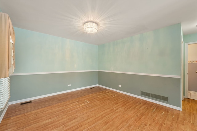 unfurnished room featuring hardwood / wood-style flooring