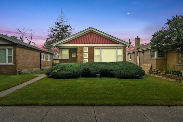 bungalow-style home featuring a lawn