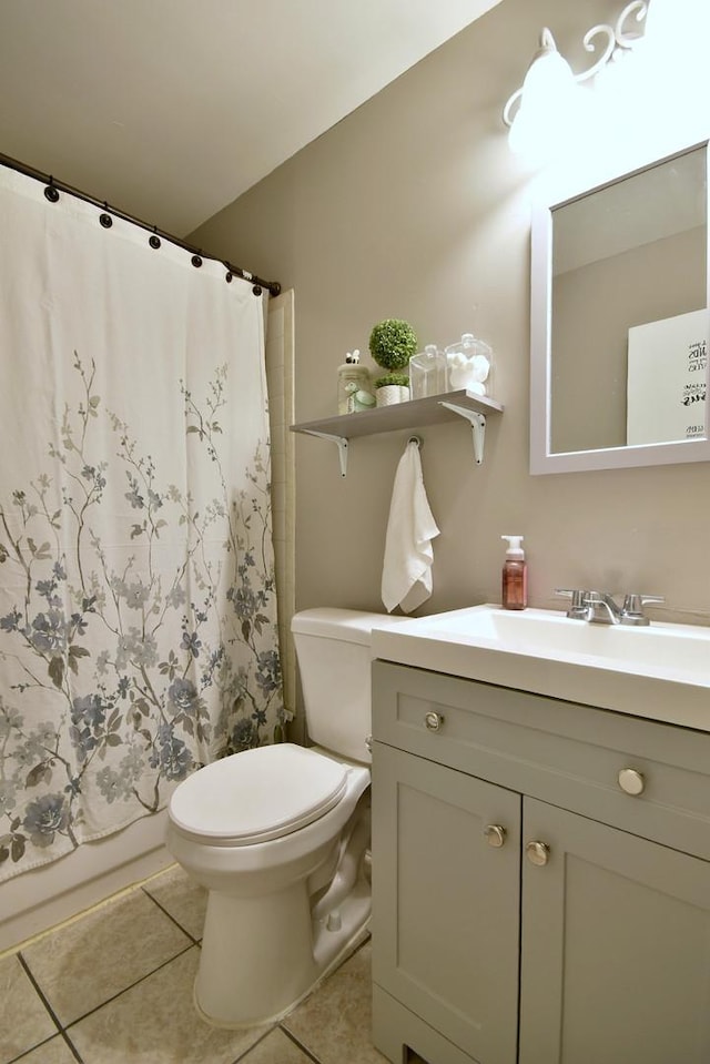 full bathroom with vanity, toilet, tile patterned floors, and shower / tub combo