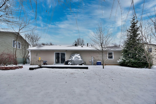 view of snow covered rear of property