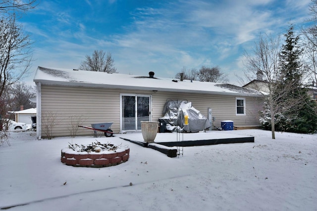 view of snow covered rear of property