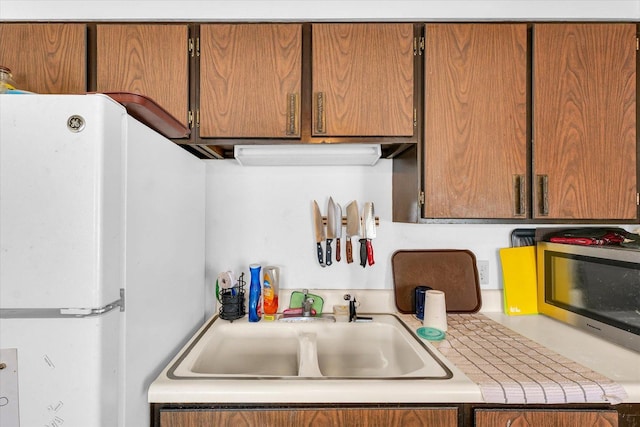 kitchen with sink and white fridge