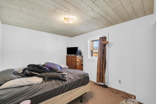 bedroom with wooden ceiling and carpet