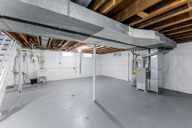 basement with heating unit, sink, and water heater