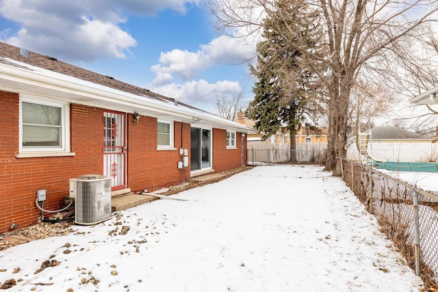 yard covered in snow featuring central AC