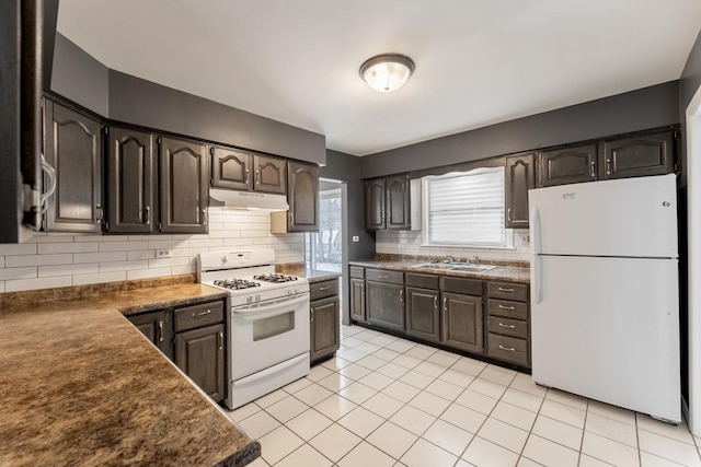 kitchen featuring sink, white appliances, backsplash, dark brown cabinets, and light tile patterned flooring