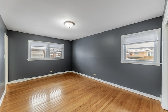 unfurnished room featuring a healthy amount of sunlight and light hardwood / wood-style flooring