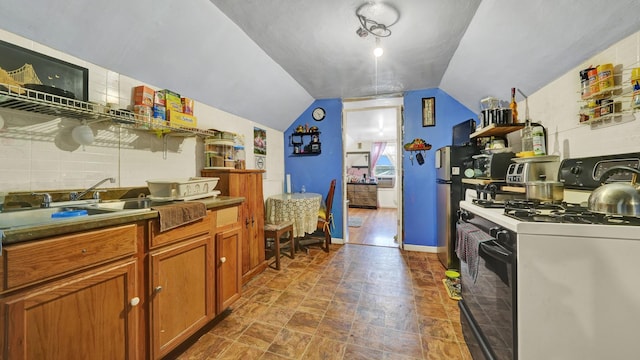 kitchen with lofted ceiling and gas stove