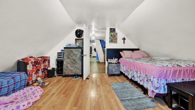 bedroom featuring lofted ceiling and hardwood / wood-style flooring