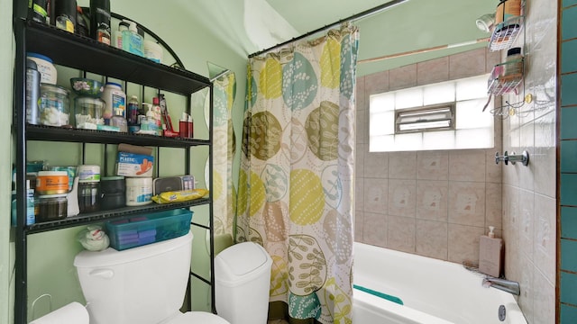 bathroom featuring toilet and shower / bath combo