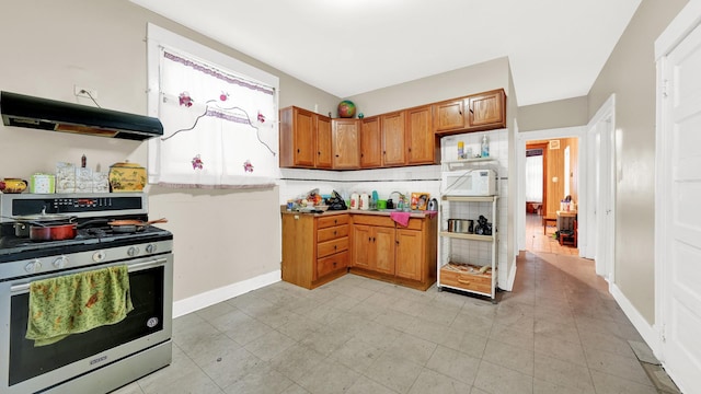 kitchen with backsplash and stainless steel gas stove