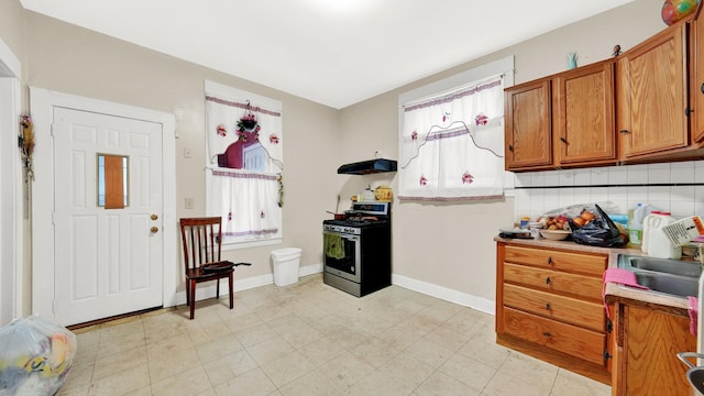 kitchen with sink, backsplash, and stainless steel gas range