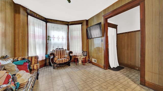 living area featuring wood walls