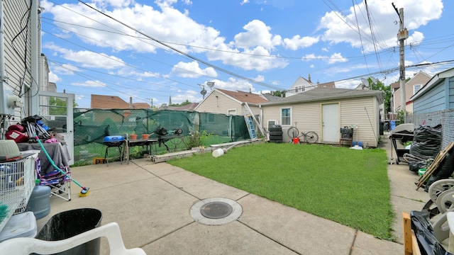 view of yard featuring an outbuilding and a patio