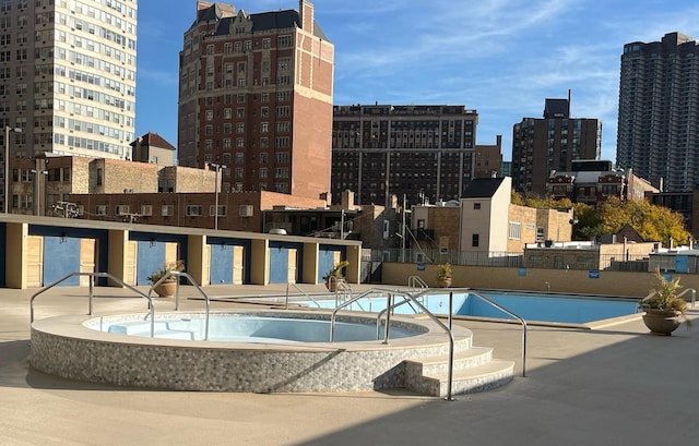 view of swimming pool featuring sink, a patio, and a community hot tub