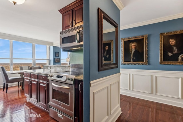 kitchen with crown molding, dark hardwood / wood-style flooring, and stainless steel appliances