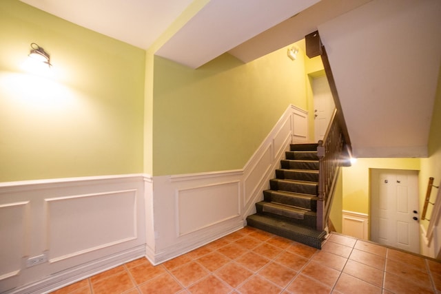 stairway with tile patterned floors