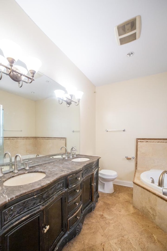 bathroom with toilet, a chandelier, tiled tub, and vanity