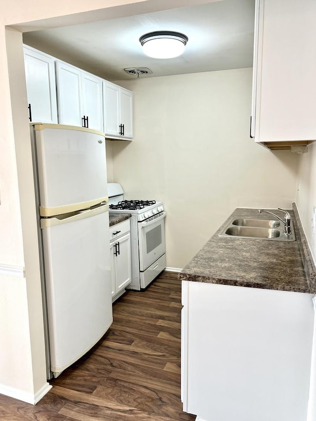 kitchen with white cabinetry, sink, white appliances, and dark hardwood / wood-style flooring