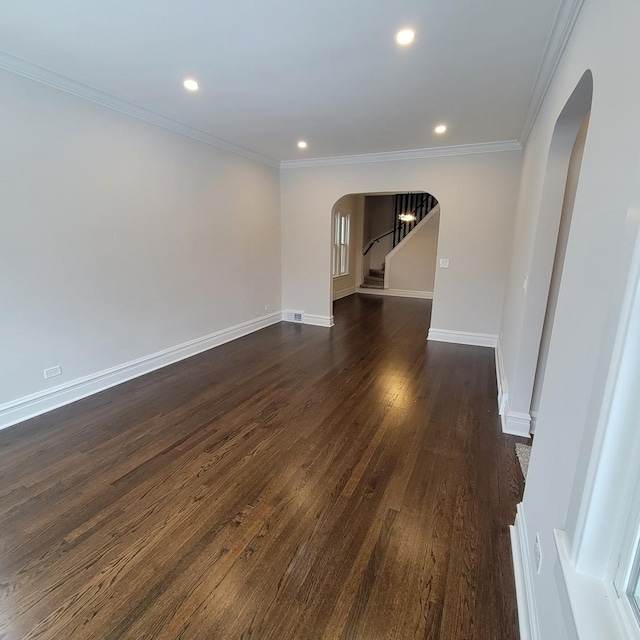 spare room with dark hardwood / wood-style flooring and ornamental molding