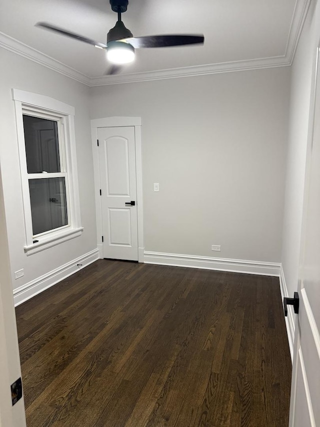 spare room featuring ceiling fan, ornamental molding, and dark hardwood / wood-style flooring