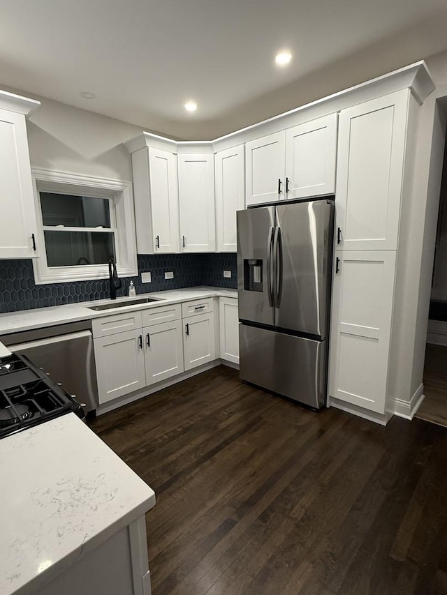 kitchen featuring white cabinetry, dark hardwood / wood-style flooring, tasteful backsplash, sink, and stainless steel fridge with ice dispenser