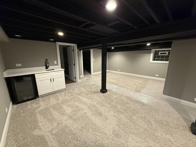 basement featuring light colored carpet and sink