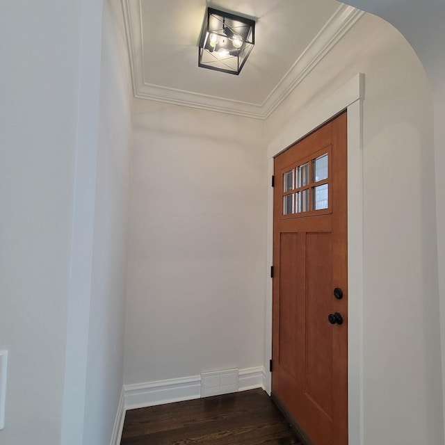 entrance foyer with dark hardwood / wood-style floors and ornamental molding