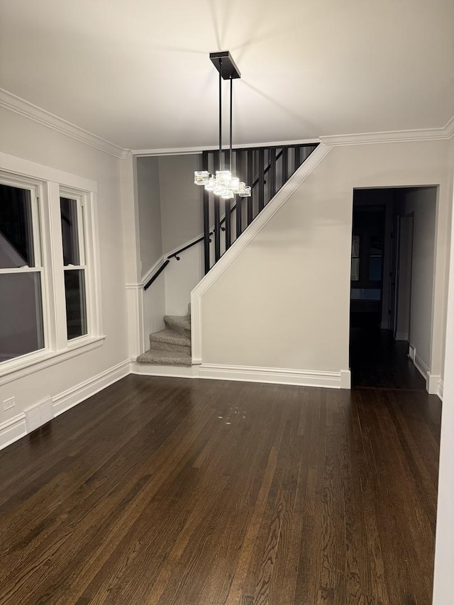 interior space with a notable chandelier, crown molding, and dark hardwood / wood-style floors