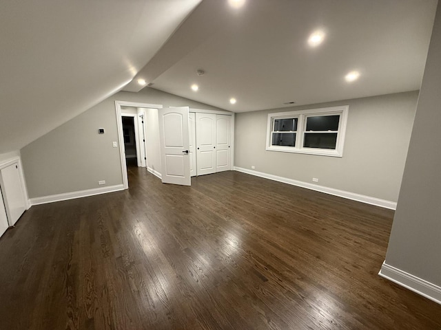 additional living space featuring dark hardwood / wood-style flooring and lofted ceiling