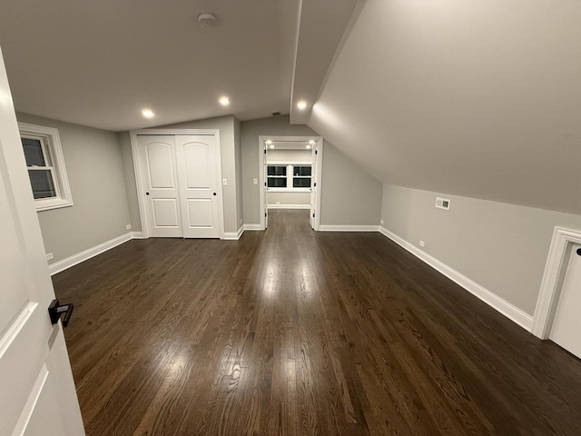 bonus room featuring dark hardwood / wood-style flooring and vaulted ceiling