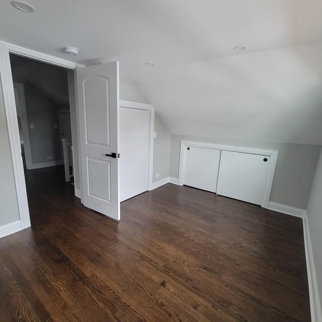 bonus room featuring dark hardwood / wood-style floors and lofted ceiling