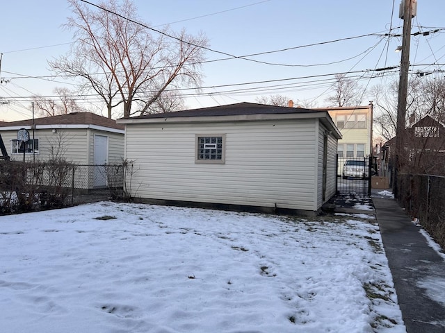 view of snow covered back of property