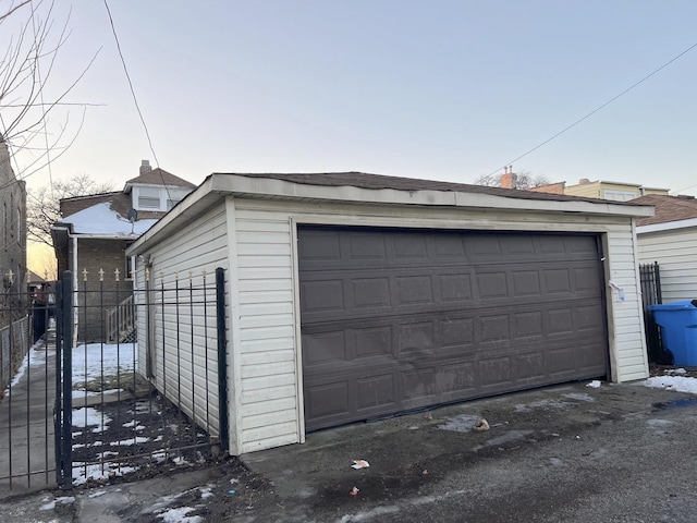 view of garage at dusk