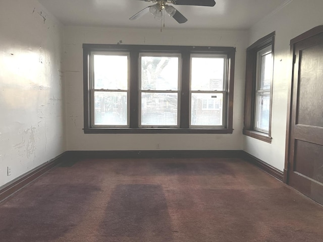 carpeted empty room featuring ceiling fan